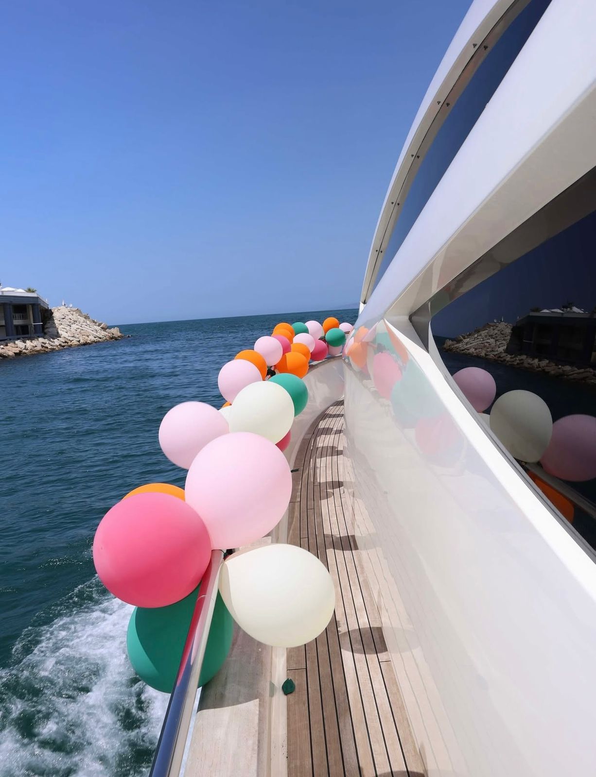 Colorful balloon decorations along the deck of a Vipyachting luxury yacht