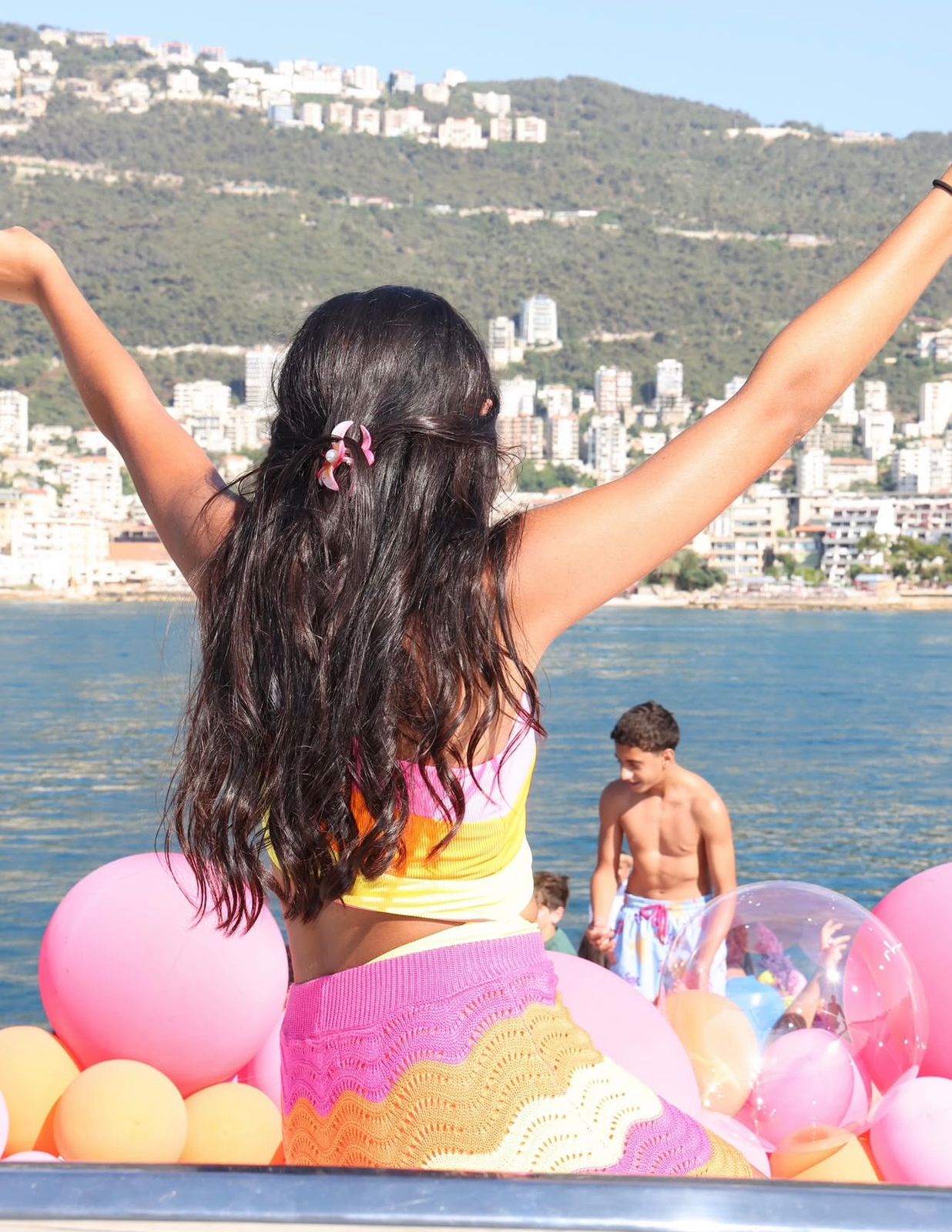 Guest celebrating on a Vipyachting yacht with balloons and ocean view