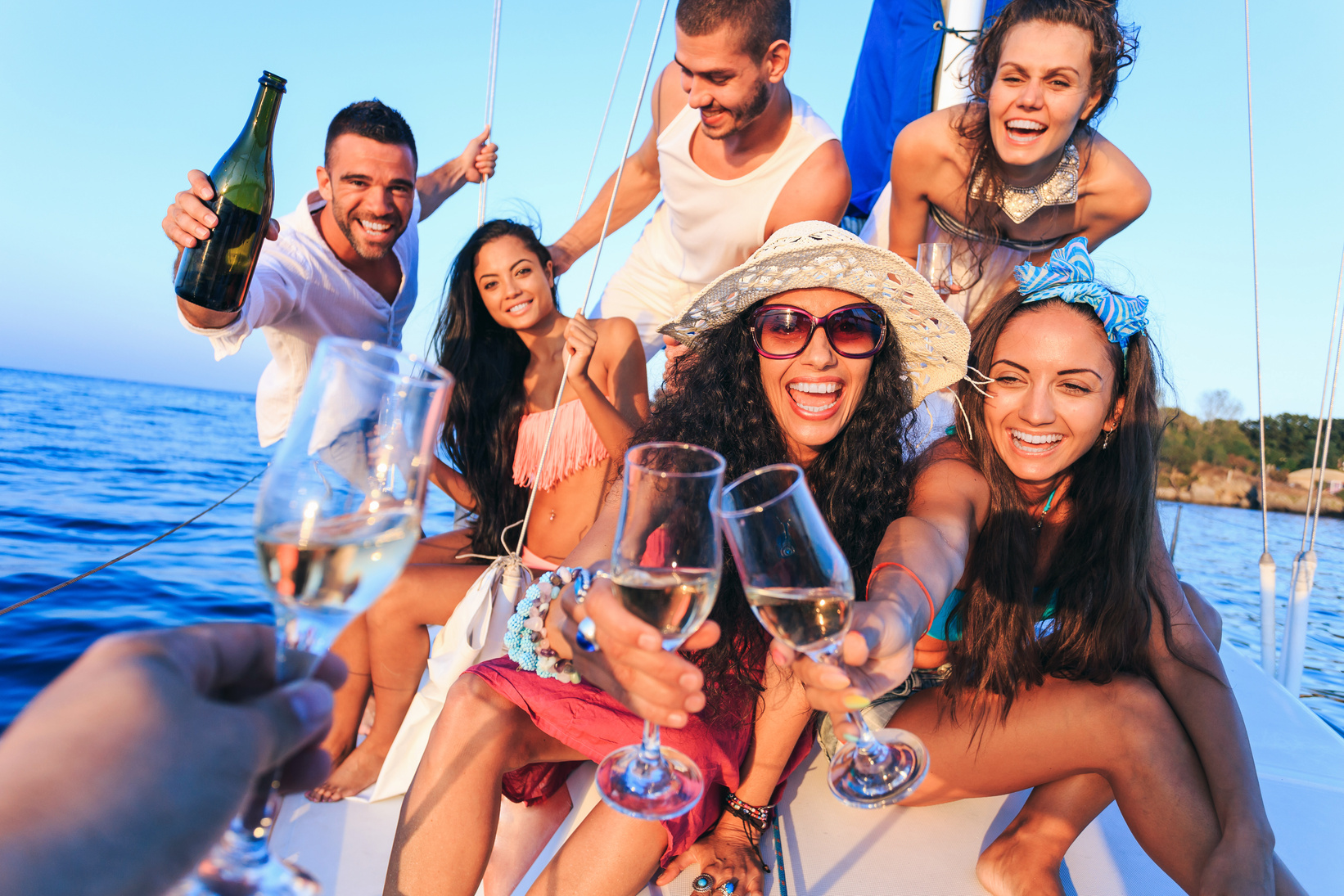 Friends having champagne party on yacht